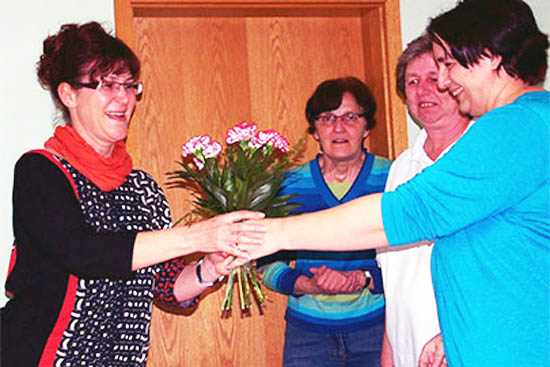 Der Gewinnerin des Speckfettswettbewerbs wird ein Blumenstrauß überreicht